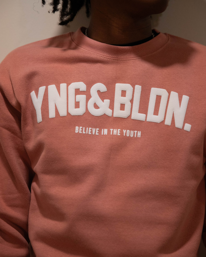 Discover elevated comfort and style with the YNG & BLDN ARCH Premium Crewneck Sweatshirt by Young and Building. Elevate your wardrobe with this high-quality, fashion-forward piece designed for the modern hustler. Upgrade your fashion game with the premium pullover in our dusty rose color with white puff print