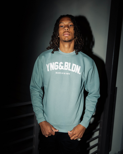 Discover elevated comfort and style with the YNG & BLDN ARCH Premium Crewneck Sweatshirt by Young and Building. Elevate your wardrobe with this high-quality, fashion-forward piece designed for the modern hustler. Upgrade your fashion game with the premium pullover in our agave blue, light teal, seafoam color with white puff print